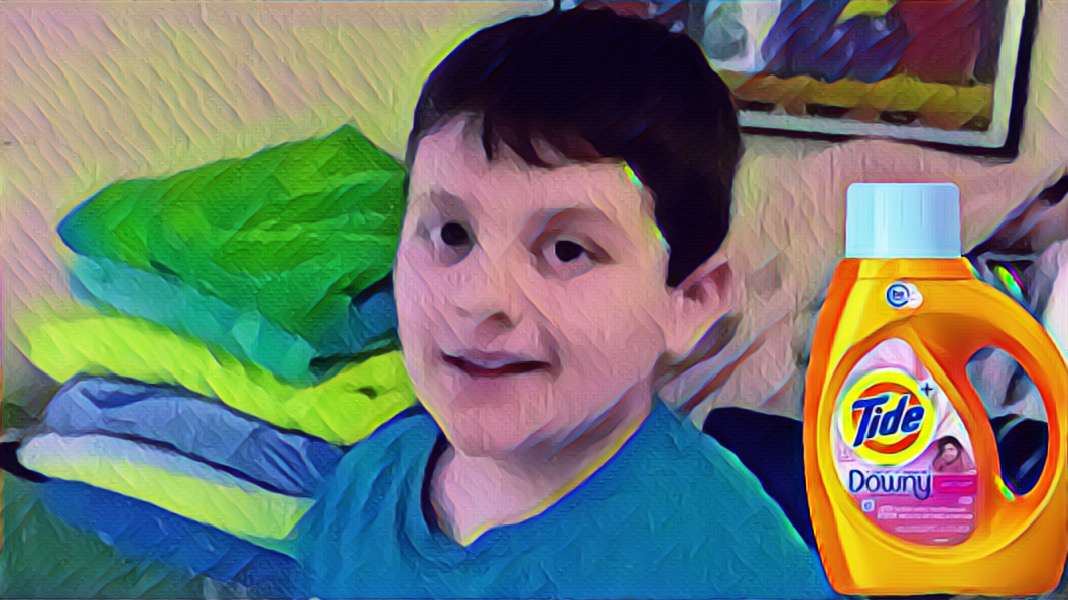 Sylized photo of Michael standing with folded towels and tide.