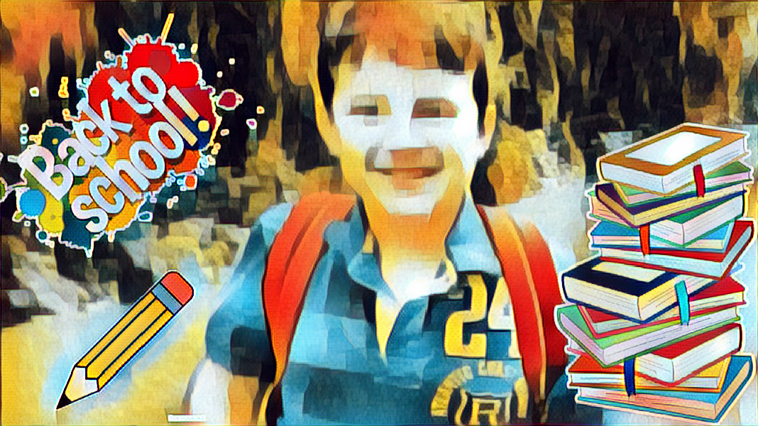 Michael with a back to school sign, a backpack, books and a pencil.