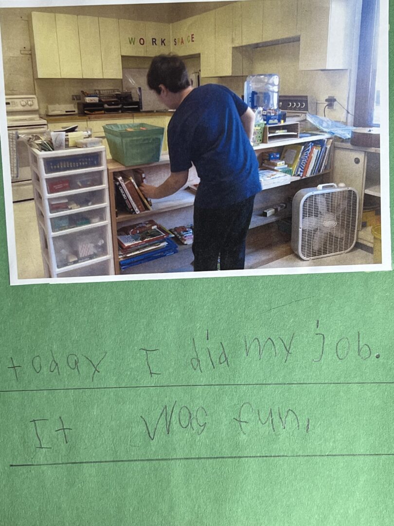 Michael shelving books in his middle school classroom.