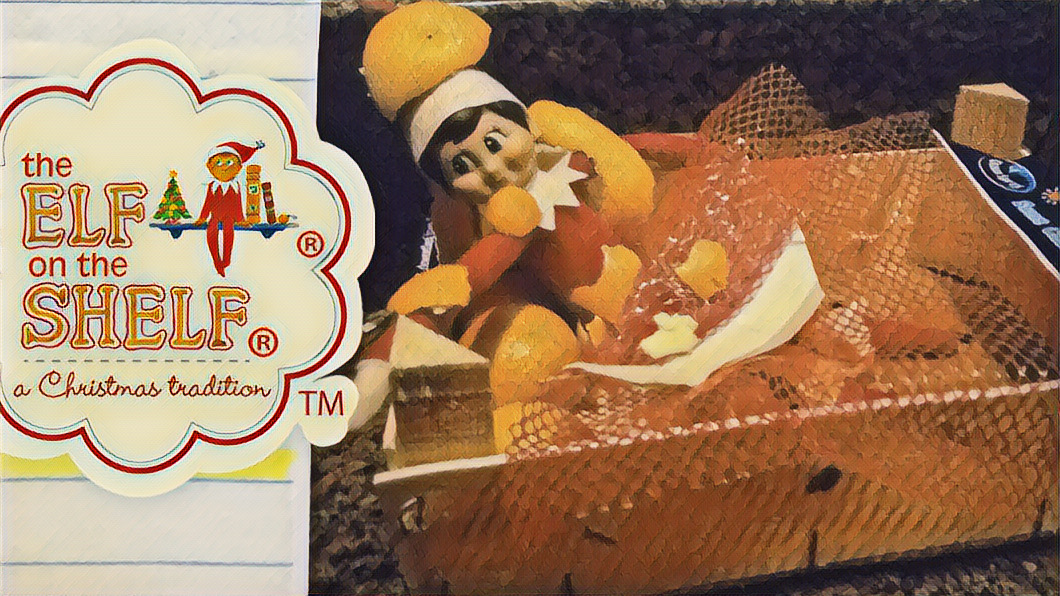 Close up of elf on the shelf in the clementine crate covered in peels with the Elf on the Shelf logo