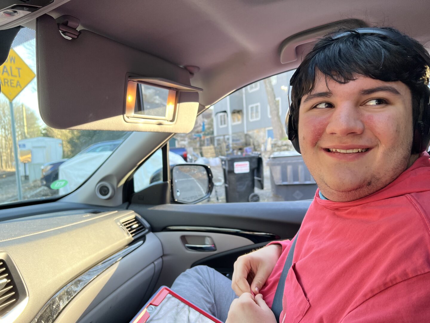 Mikey, window rolled down, happily waiting for the train to pass.