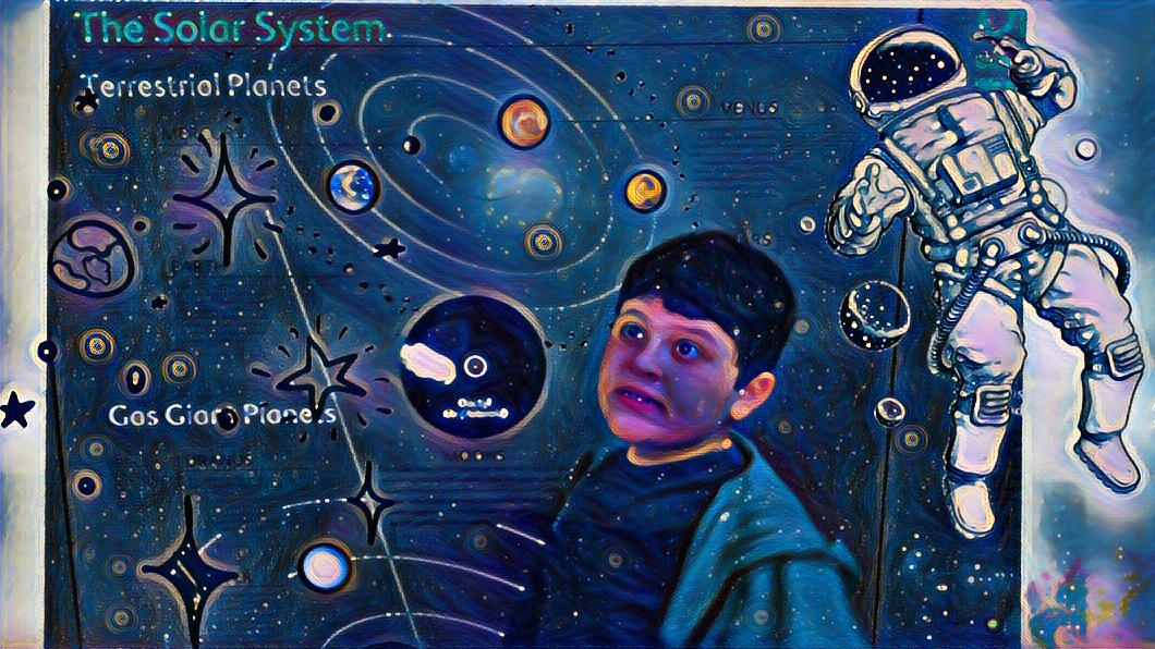Mikey standing in front of a solar system display outside the planetarium.