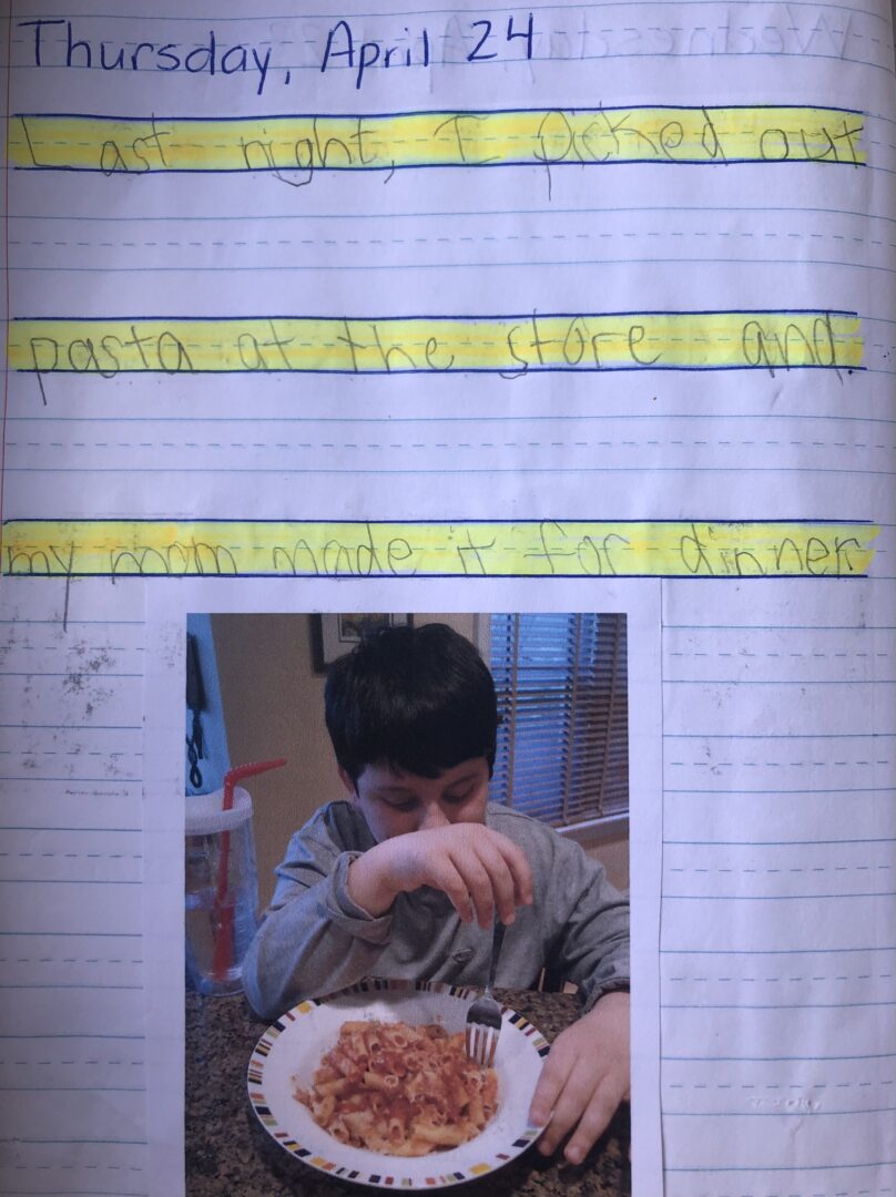 Journal entry for April 24, 2014. "Last night, I picked out pasta at the store and my mom made it for dinner." Mikey eating his pasta with his water cup next to him.