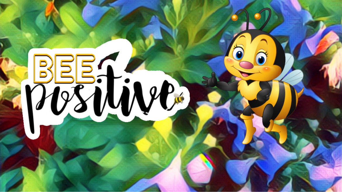 flowers in the background, a cartoon happy bee and the phrase 'bee positive'