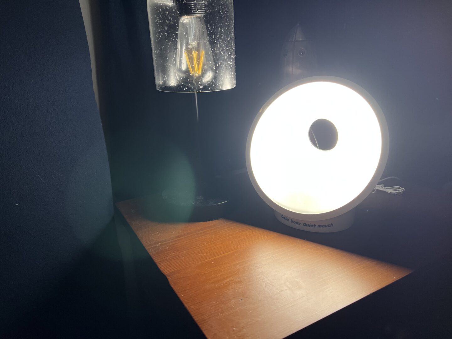 Mikey's bedside table with an alarm clock that lights up gradually to wake him.