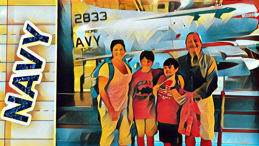 Our family posing in front of a plane on the Intrepid. Navy sticker.