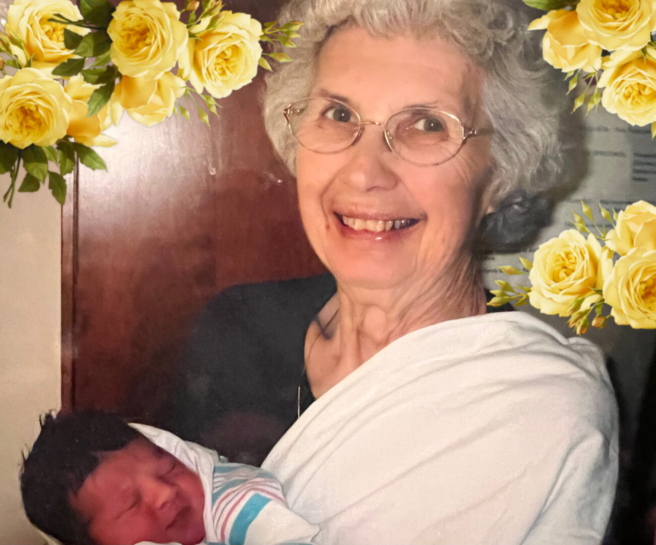 My grandmother holding Mikey on the day he was born, Mikey wrapped in his hospital blanket with a full head of black hair.