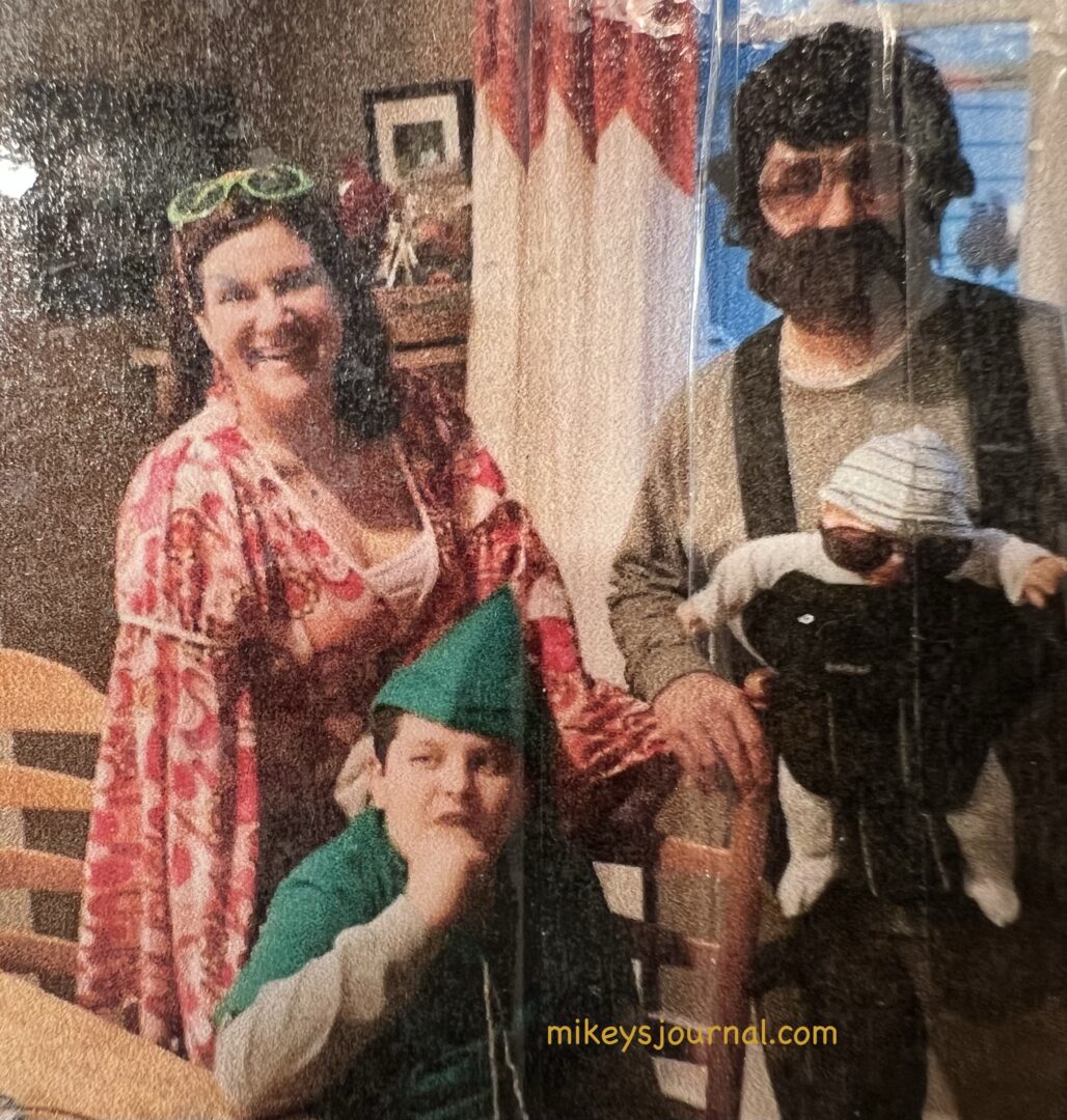 Mom, Dad and Mikey in costume at the party.