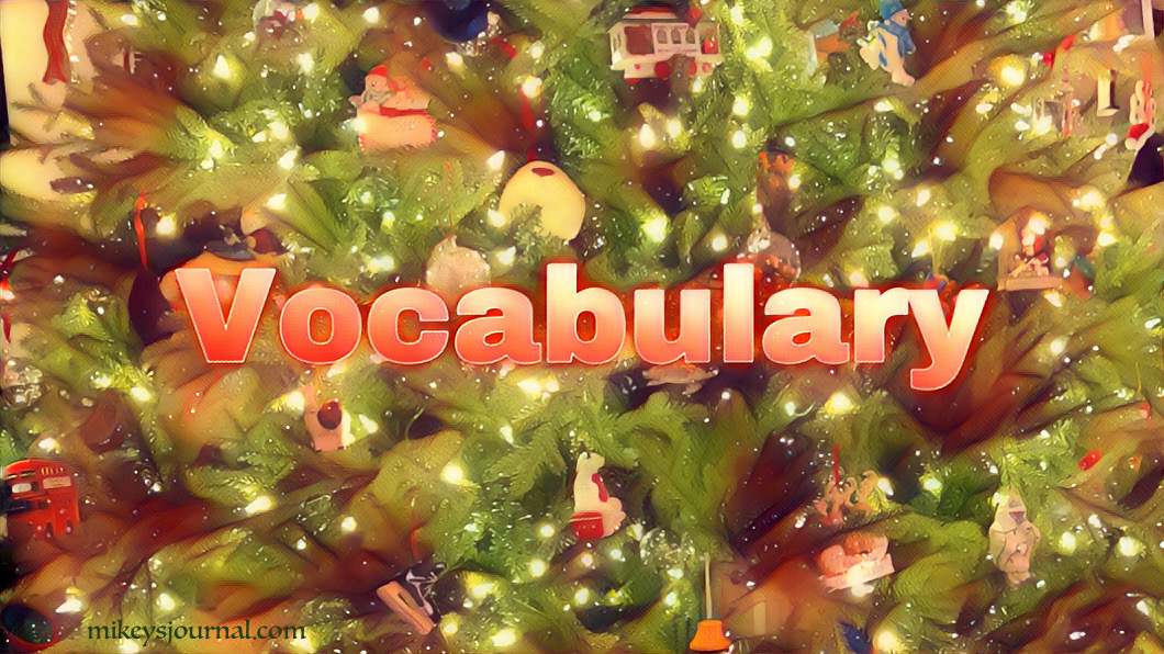 Close up of the lit Christmas tree with ornaments and the title Vocabulary
