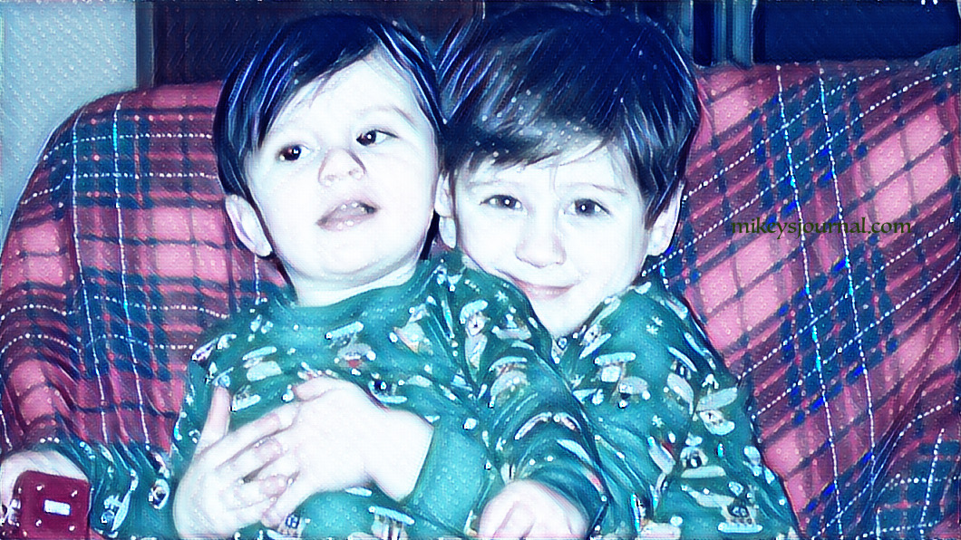 Baby Will and Mikey, Will hugging Mikey from behind, wearing their Christmas pajamas.