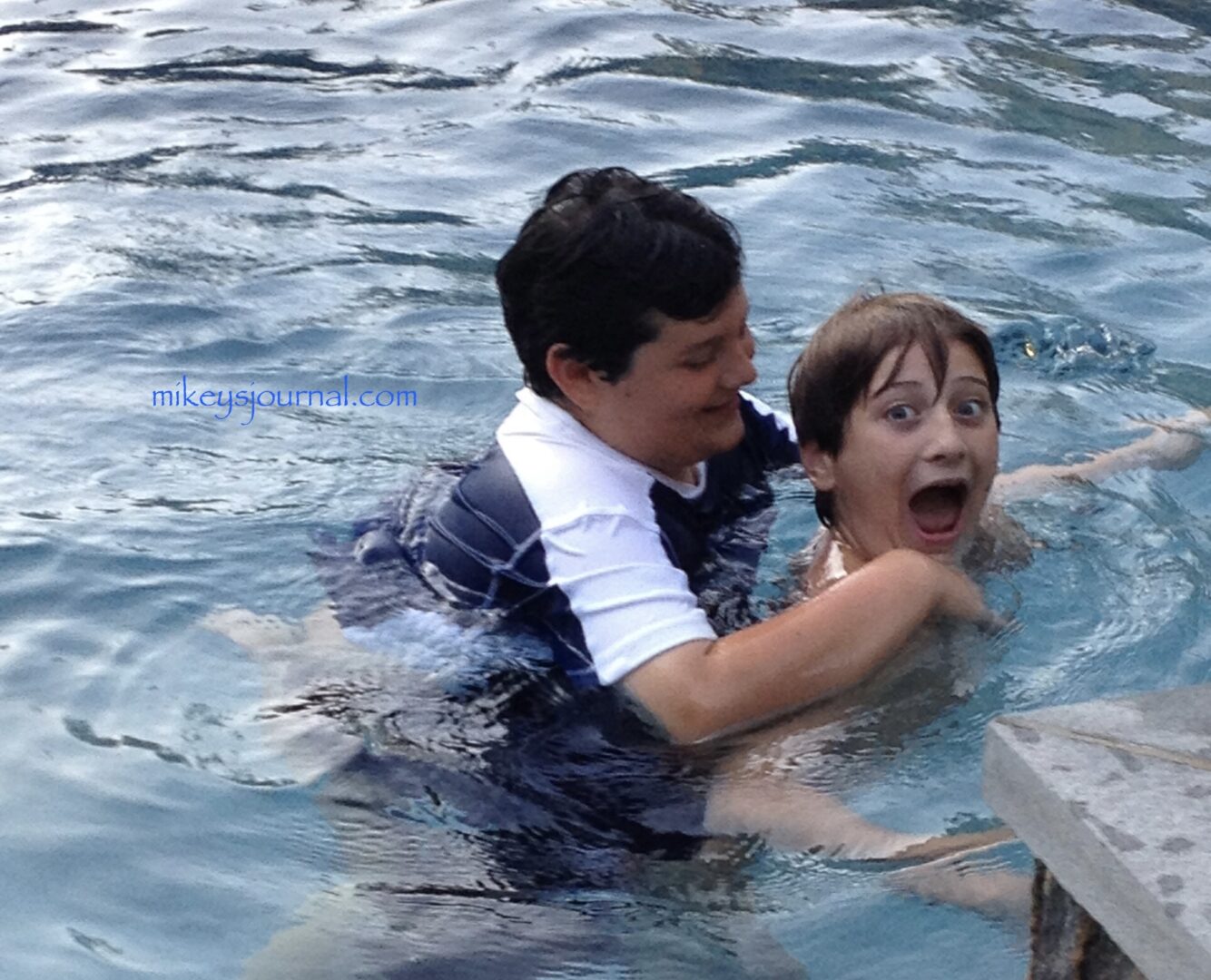 Will giving Mikey a piggyback ride in the pool.