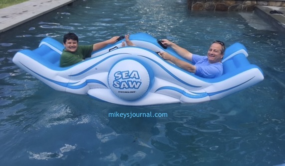 Dave and Mikey on the giant inflatable sea saw in the pool.