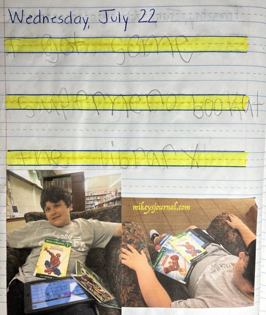 journal entry from Wednesday, July 22. 'I got some superhero book at the library." 2 photos of Mikey, sitting in a comfy chair at the library holding his superhero books and his talking iPad.