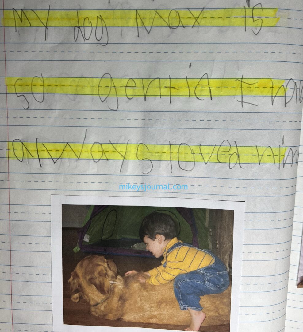 photo of baby mikey in a yellow turtleneck and jean overalls sitting on top of our golden retriever as he is laying down.