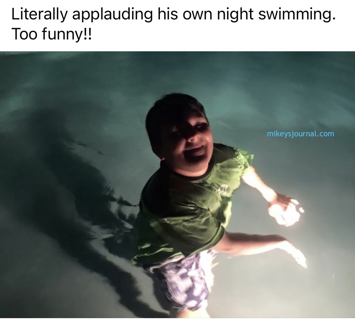 My Facebook post, Michael standing in the water in the pool light, clapping for himself.
