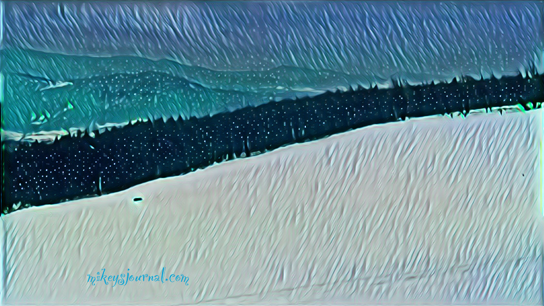 stylized photo of a snowy hill with woods, mountains and sky in the background.