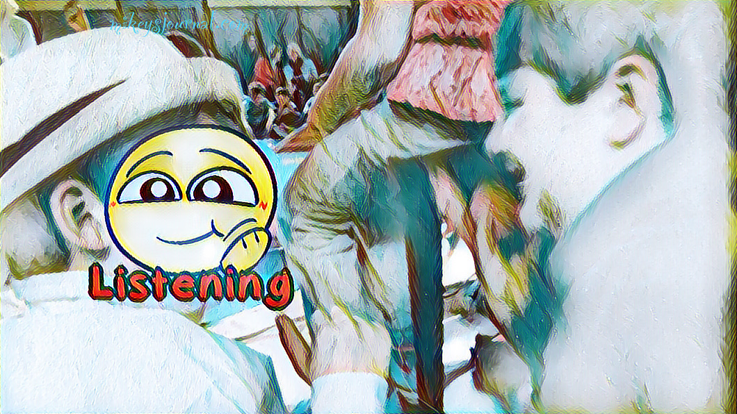 stylized photo of Mikey talking to a friend at a school assembly. His friend’s face is obscured by a listening emoji.