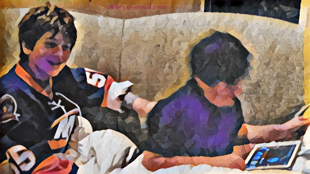 stylized photo of Will and Mikey on the couch, Will watching hockey in his islanders jersey and mikey searching videos on youtube on his ipad.