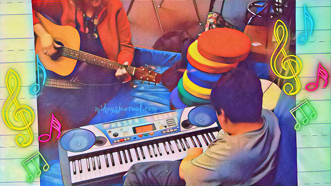 C32EE9A7-8541-4BA2-A4B8-F53D1707267F stylized colorful photo of Miss M playing the guitar and Mikey trying out some notes on the electric keyboard. neon music notes added for effect