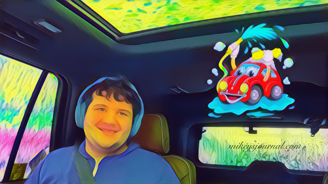 stylized photo of Mikey in the car surrounded by the tricolor foam in the car wash, car wash sticker added for effect