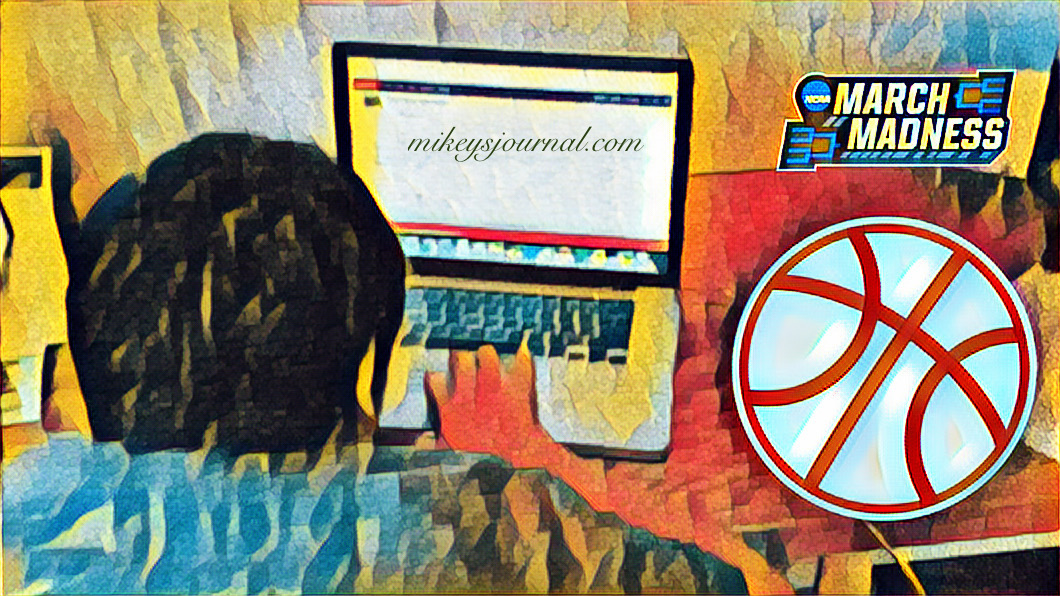stylized photo of Mikey clicking on the laptop mouse, ‘march madness’ sign, basketball sticker