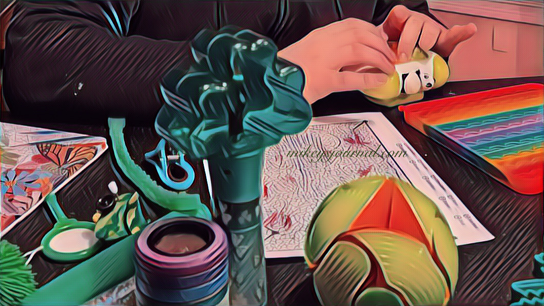 stylized photo of Mikey’s ‘command center’ with tons of toys and his hands at work playing his panda game