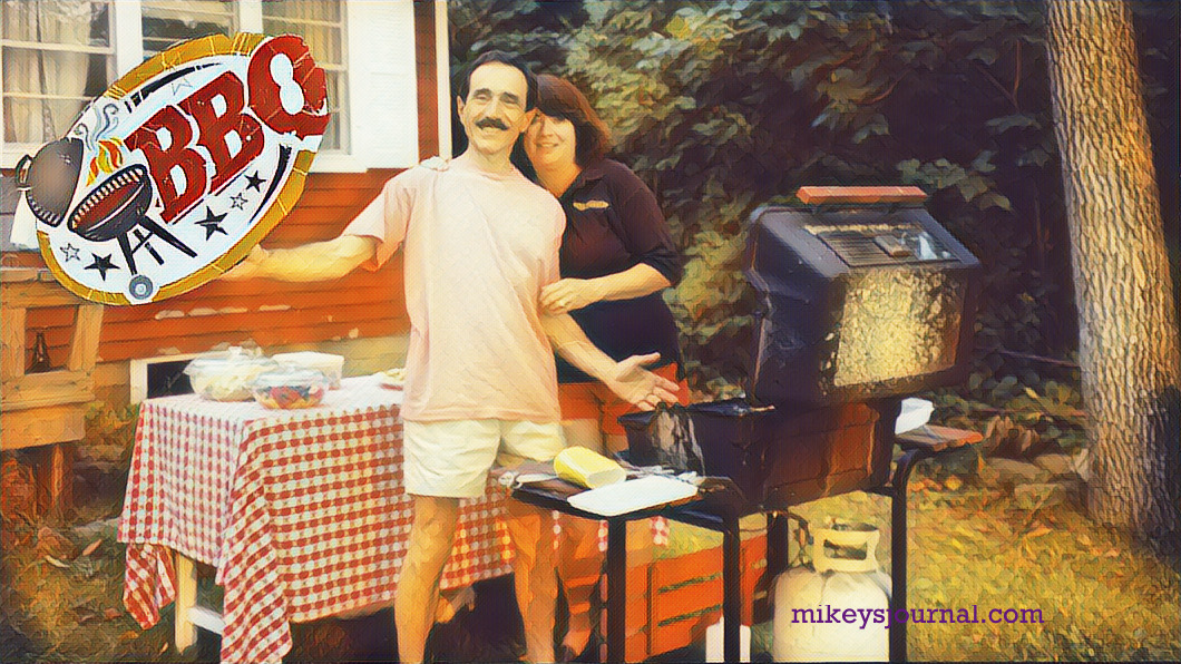 Mimi and pop smiling at the grill, red. checkered tablecloth and side dishes in the background