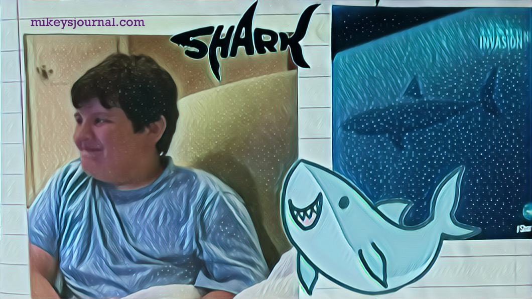 stylized photo of mikey watching shark week from the couch with his white blanket, shark stickers added for fun