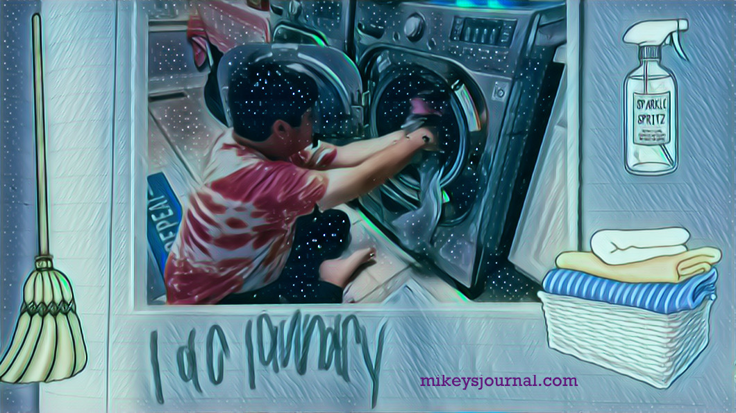 stylized photo of mikey sitting on the laundry room floor loading the washing machine. Stickers of a broom, spray bottle and folded laundry added for fun. In Mikey’s handwriting, “i do laundry."